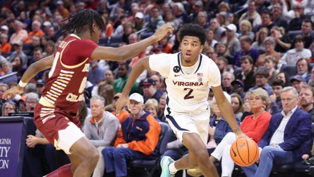 Reece Beekman drives the ball during the Virginia men's basketball game against Boston College at John Paul Jones Arena.
